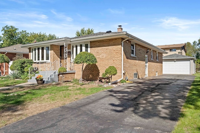 single story home with a garage, covered porch, and an outbuilding