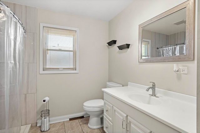 bathroom with tile patterned floors, vanity, walk in shower, and toilet