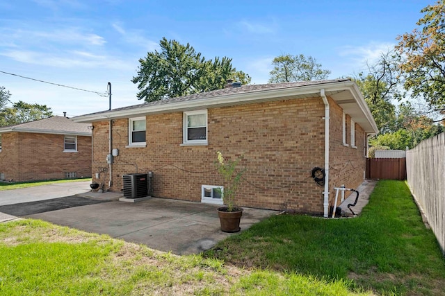 back of house with a lawn, a patio area, and central air condition unit