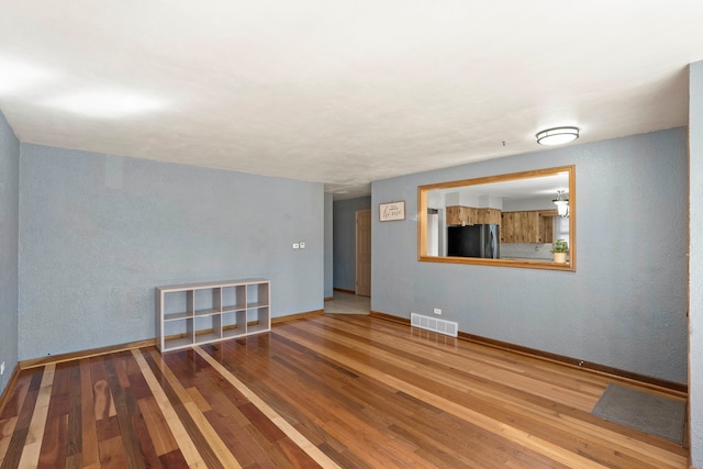 empty room with wood-type flooring