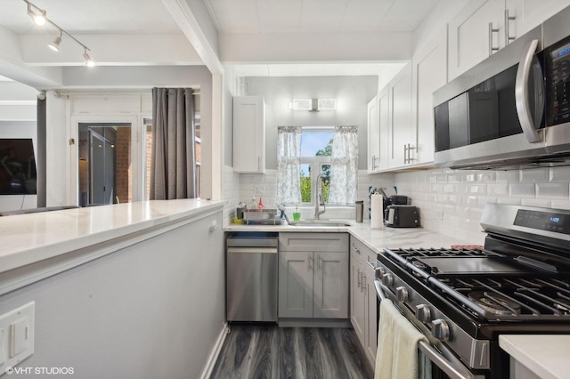 kitchen featuring white cabinetry, decorative backsplash, sink, and stainless steel appliances