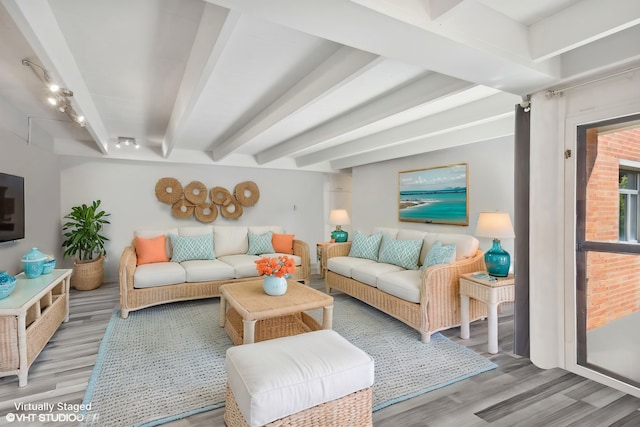 living room with beam ceiling and light wood-type flooring