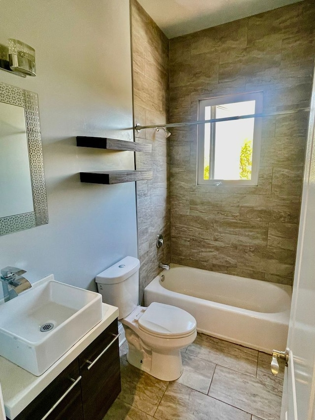 full bathroom with toilet, vanity, and tiled shower / bath