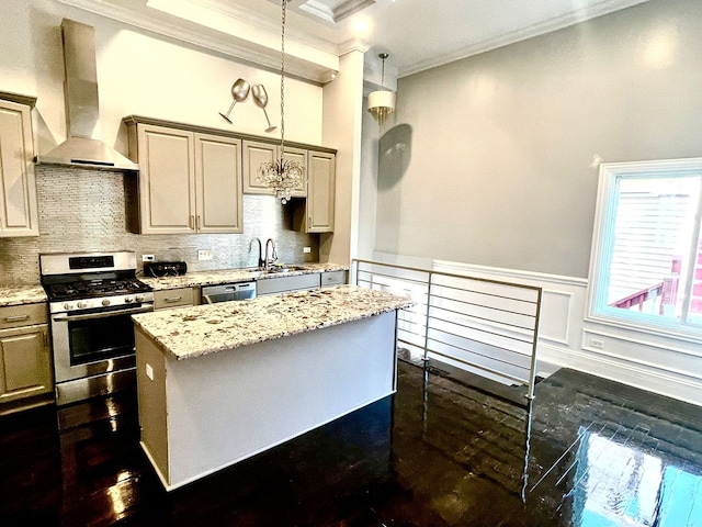 kitchen featuring crown molding, wall chimney exhaust hood, a kitchen island, light stone counters, and stainless steel appliances