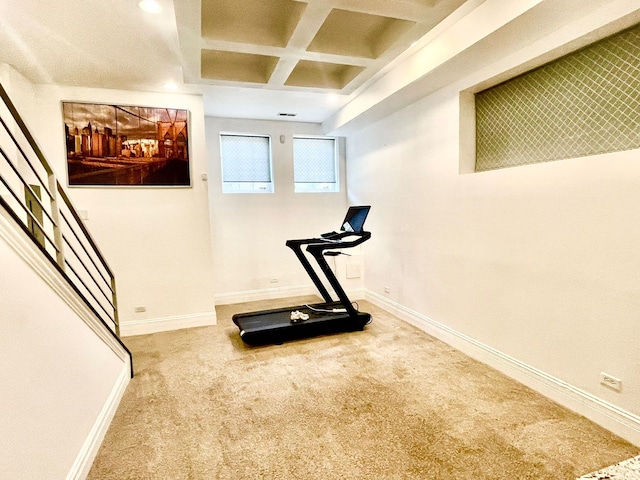 exercise room with carpet floors and coffered ceiling