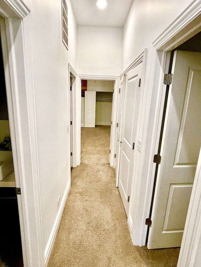 corridor featuring light colored carpet