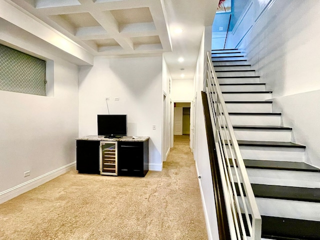 stairway with carpet, beam ceiling, and coffered ceiling