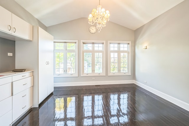 unfurnished dining area with a chandelier, dark wood-type flooring, and lofted ceiling