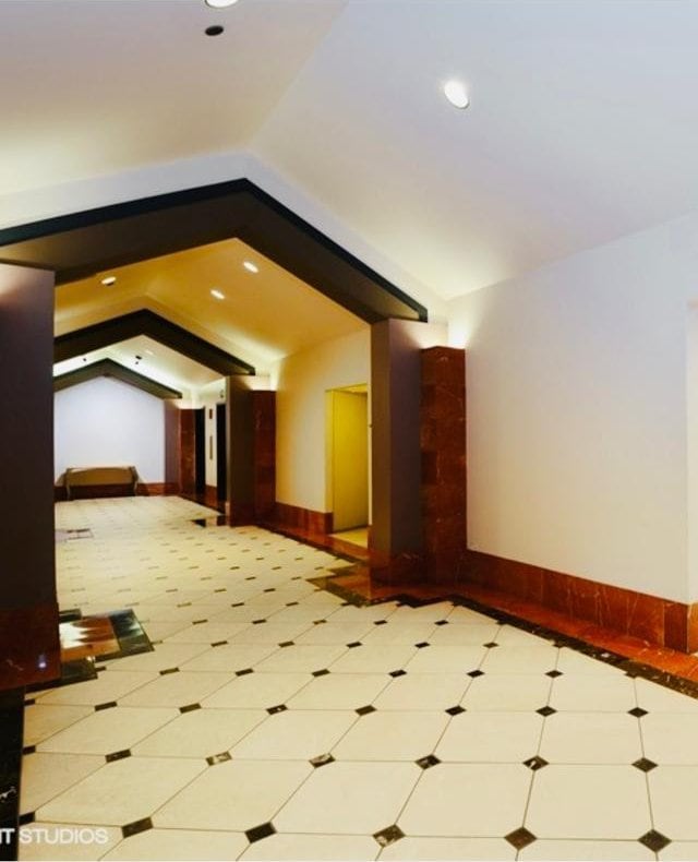 interior space with baseboards, recessed lighting, and lofted ceiling
