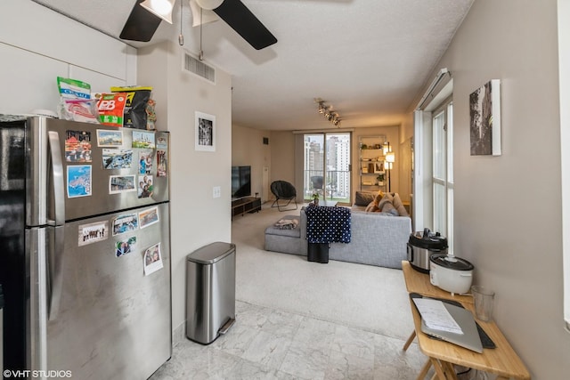 carpeted living room featuring visible vents and ceiling fan