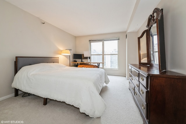 bedroom featuring light colored carpet