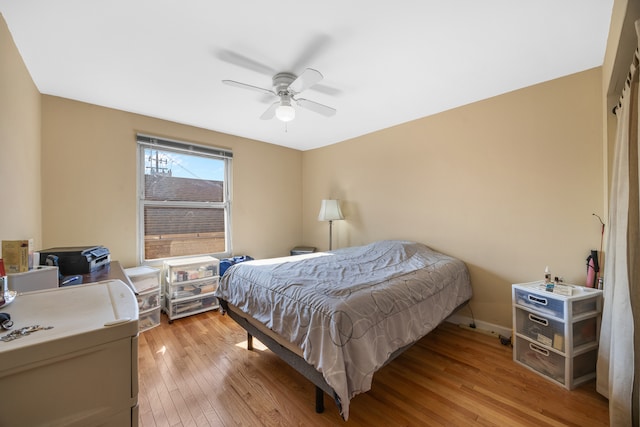 bedroom with ceiling fan and light wood-type flooring