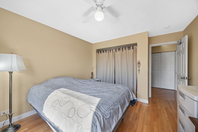 bedroom with light hardwood / wood-style floors and ceiling fan