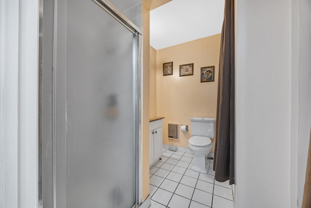 bathroom with vanity, toilet, tile patterned floors, and an enclosed shower