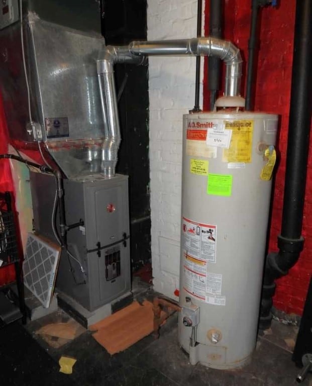 utility room with heating unit and gas water heater