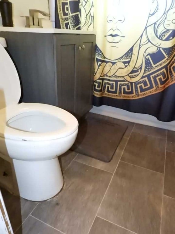 bathroom featuring toilet and tile patterned flooring