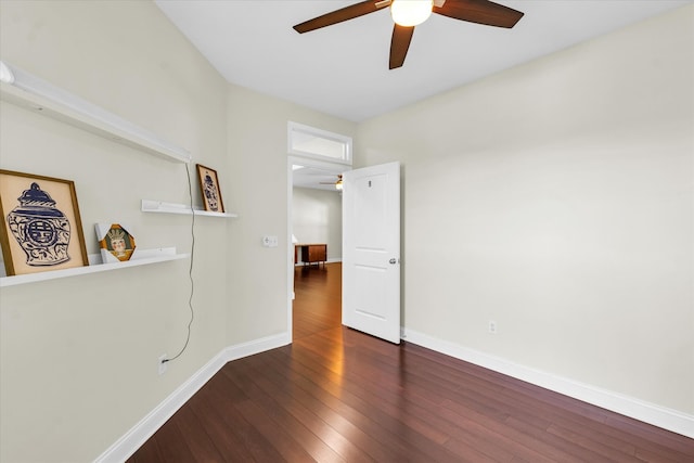 unfurnished room with dark hardwood / wood-style flooring and ceiling fan