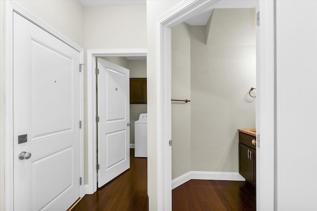 hall featuring washer / clothes dryer and dark hardwood / wood-style flooring