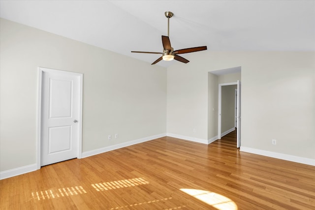 empty room featuring lofted ceiling, light hardwood / wood-style floors, and ceiling fan