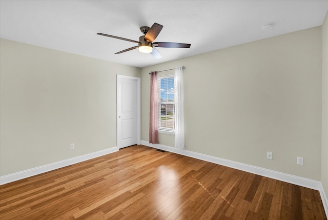 spare room with ceiling fan and light wood-type flooring