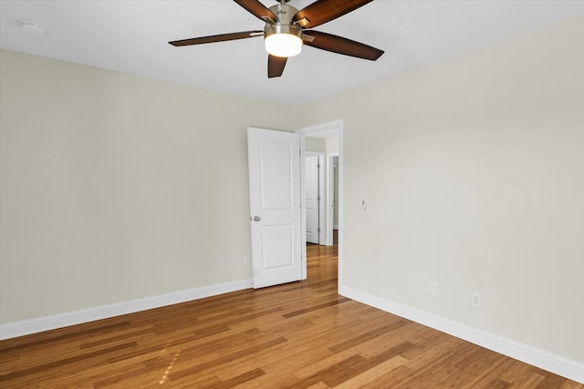 empty room with ceiling fan and light hardwood / wood-style floors