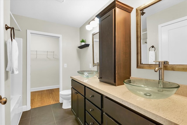 full bathroom with tile patterned floors, toilet, separate shower and tub, and vanity