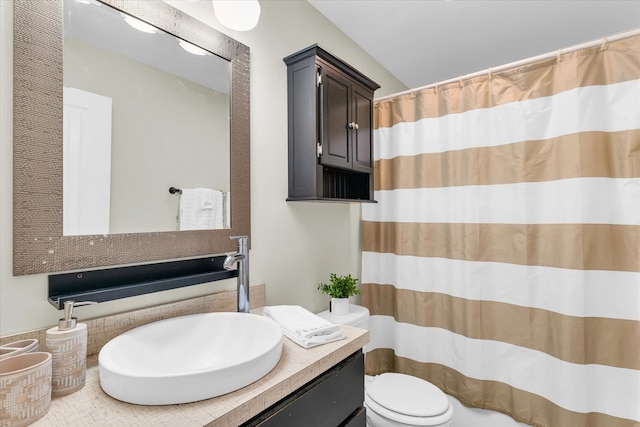 bathroom featuring walk in shower, vanity, and toilet