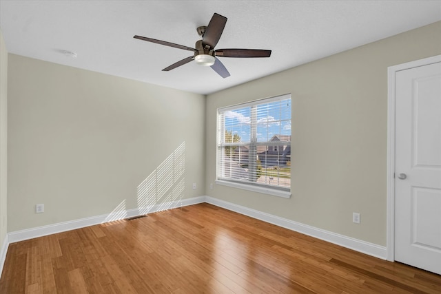 spare room with wood-type flooring and ceiling fan