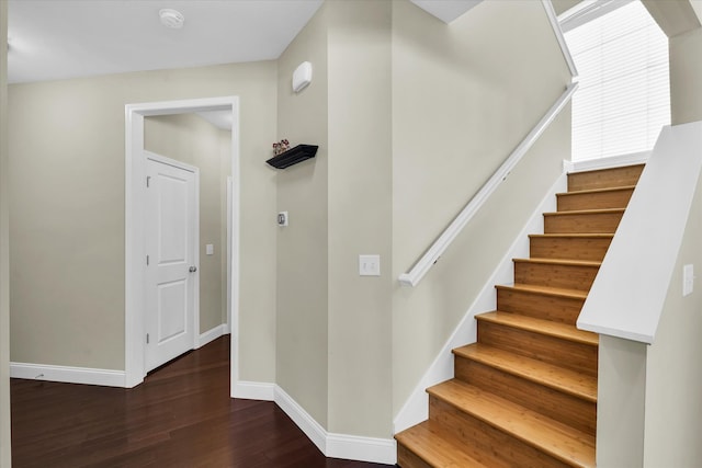 stairs featuring hardwood / wood-style floors