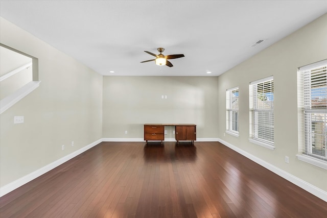 empty room featuring ceiling fan and dark wood-type flooring