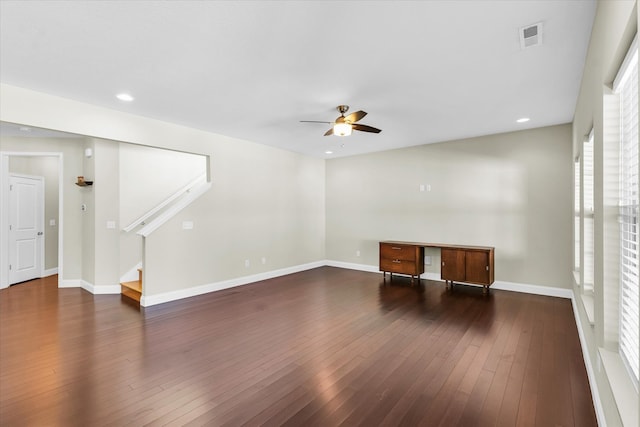 unfurnished living room with dark hardwood / wood-style floors and ceiling fan