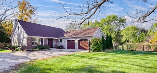 view of front of property with a front yard and a garage