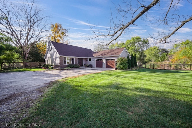 view of front of property with a front yard and a garage