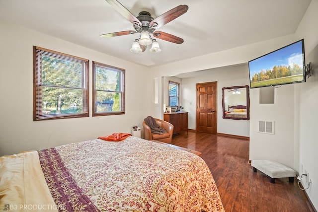 bedroom with dark hardwood / wood-style floors and ceiling fan