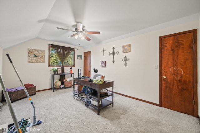 carpeted office space with vaulted ceiling and ceiling fan