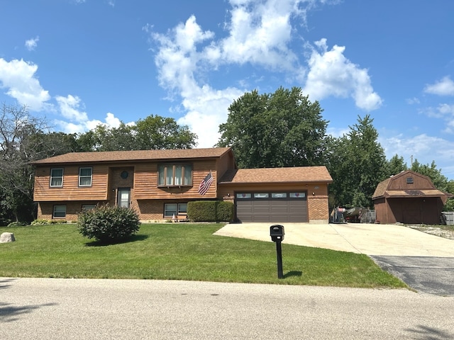 bi-level home with a storage unit, a front lawn, and a garage