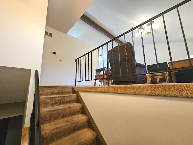 staircase with a towering ceiling