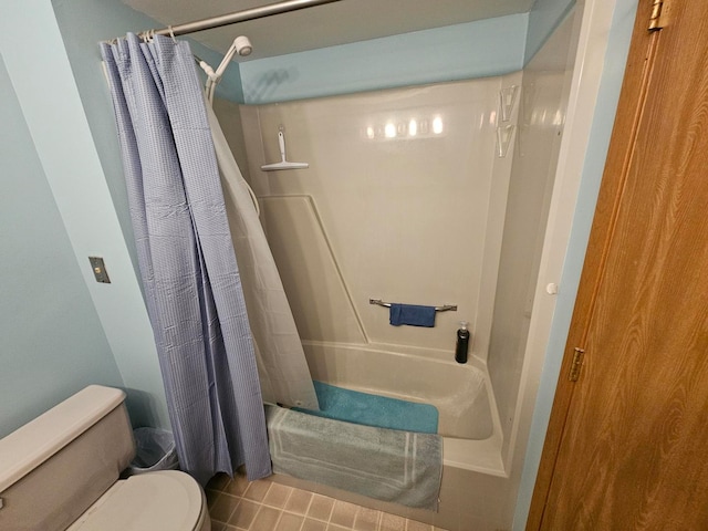 bathroom featuring tile patterned floors, toilet, and shower / bathtub combination with curtain