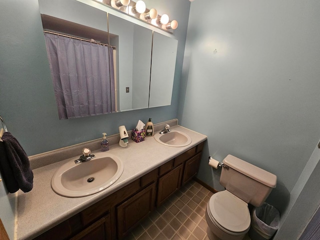 bathroom featuring toilet and vanity