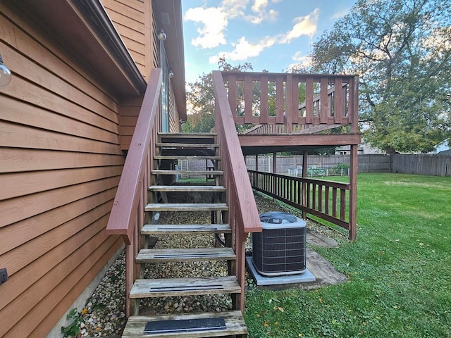 wooden terrace with central AC unit and a lawn