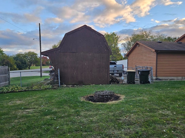 yard at dusk featuring a storage unit