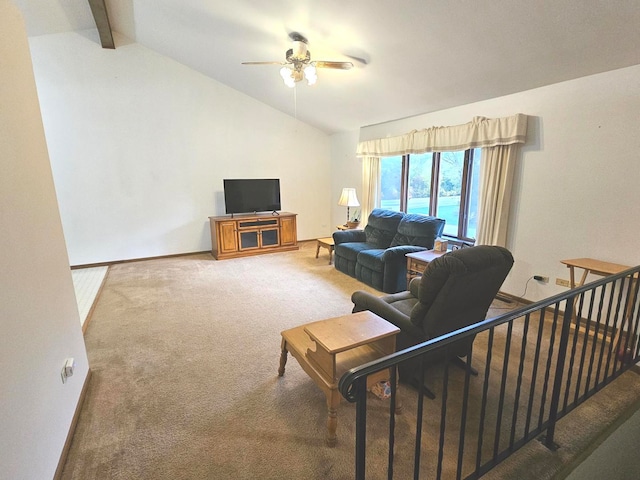 carpeted living room with ceiling fan and vaulted ceiling with beams