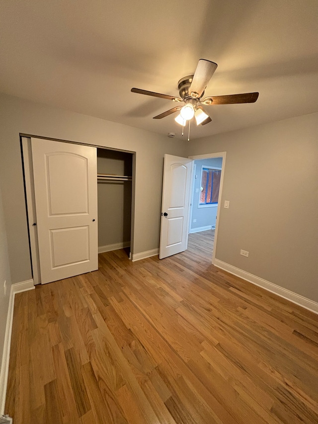 unfurnished bedroom featuring a closet, light wood-type flooring, and ceiling fan