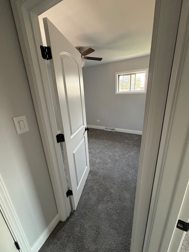 hallway with dark carpet