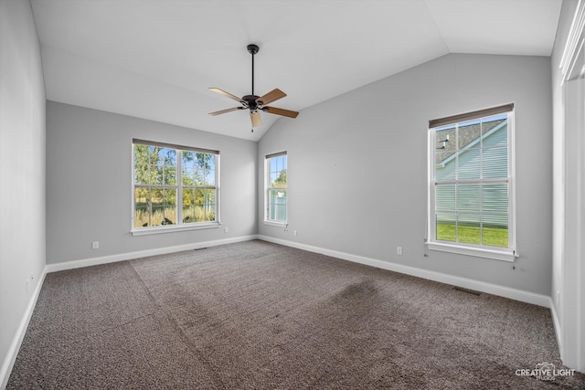 empty room featuring vaulted ceiling, carpet, and ceiling fan