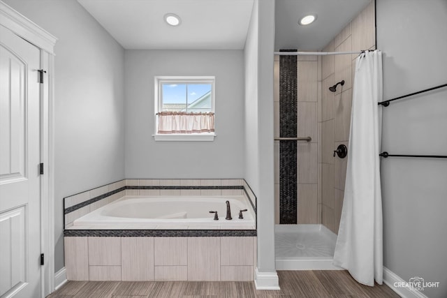 bathroom featuring separate shower and tub