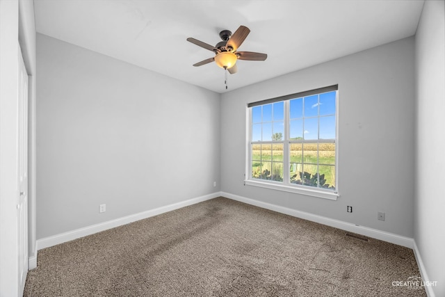 spare room featuring ceiling fan and carpet floors