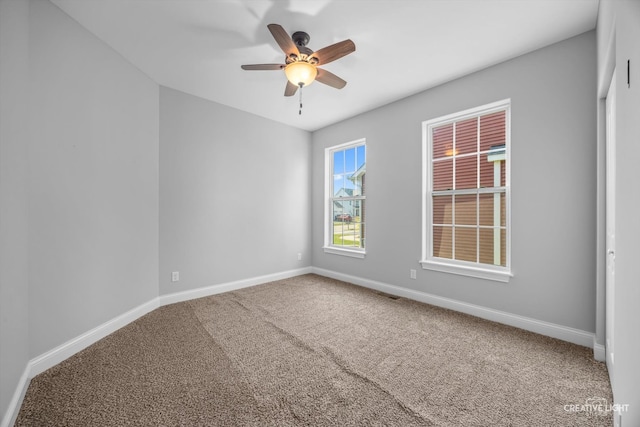 spare room featuring carpet floors and ceiling fan