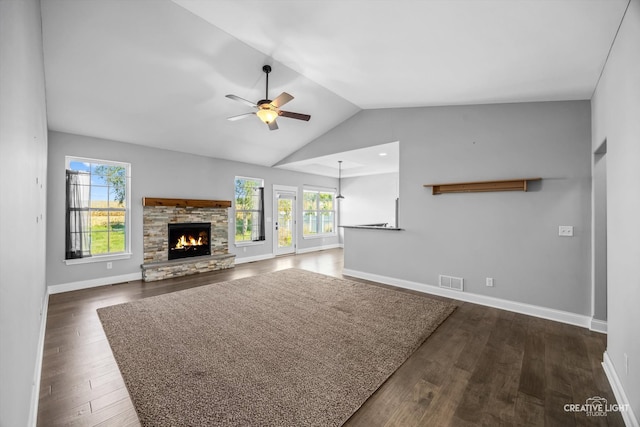 unfurnished living room with a fireplace, dark hardwood / wood-style floors, vaulted ceiling, and ceiling fan