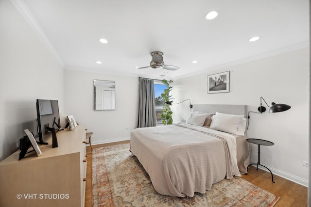 bedroom featuring light hardwood / wood-style floors, ceiling fan, and ornamental molding